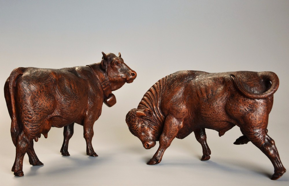 Pair of finely carved late 19th century linden wood Black Forest cows, possibly by The Huggler family