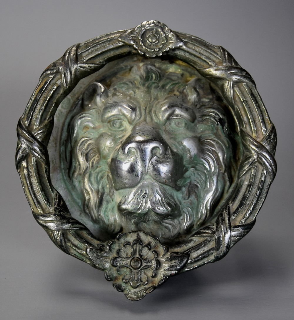 Regency bronze lion mask door knocker of large proprtions with verdigris patination