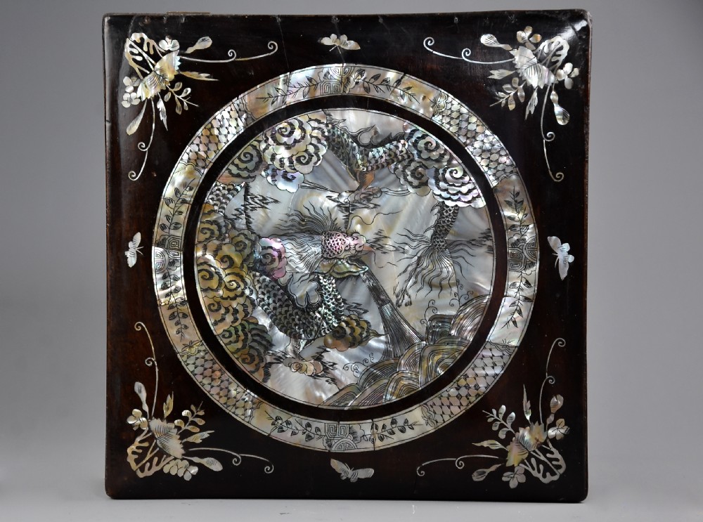 A square dark hardwood box decorated with mother-of-pearl inlay featuring a central dragon motif inside a circular frame surrounded by corner floral designs. View III