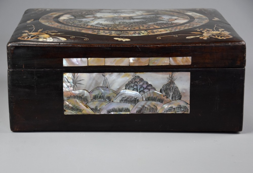 A square dark hardwood box decorated with mother-of-pearl inlay featuring a central dragon motif inside a circular frame surrounded by corner floral designs. View VII