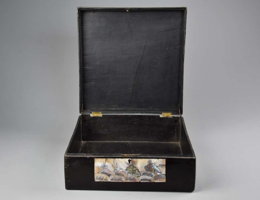 A square dark hardwood box decorated with mother-of-pearl inlay featuring a central dragon motif inside a circular frame surrounded by corner floral designs. View IX
