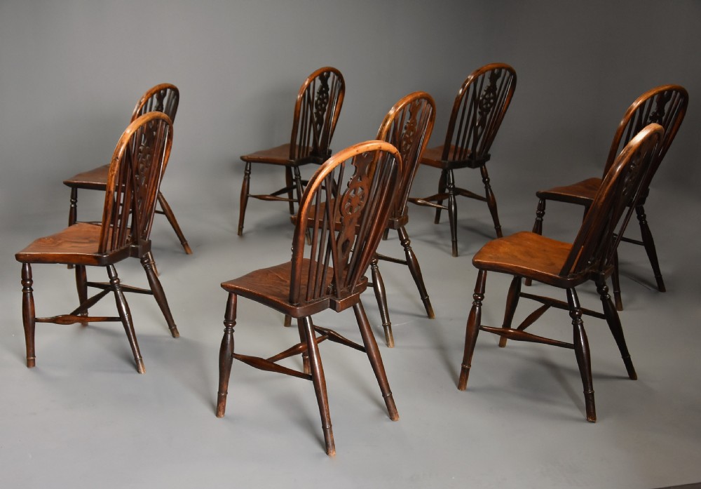Harlequin set of eight mid 19th century ash and elm wheelback Windsor chairs of superb patina View V