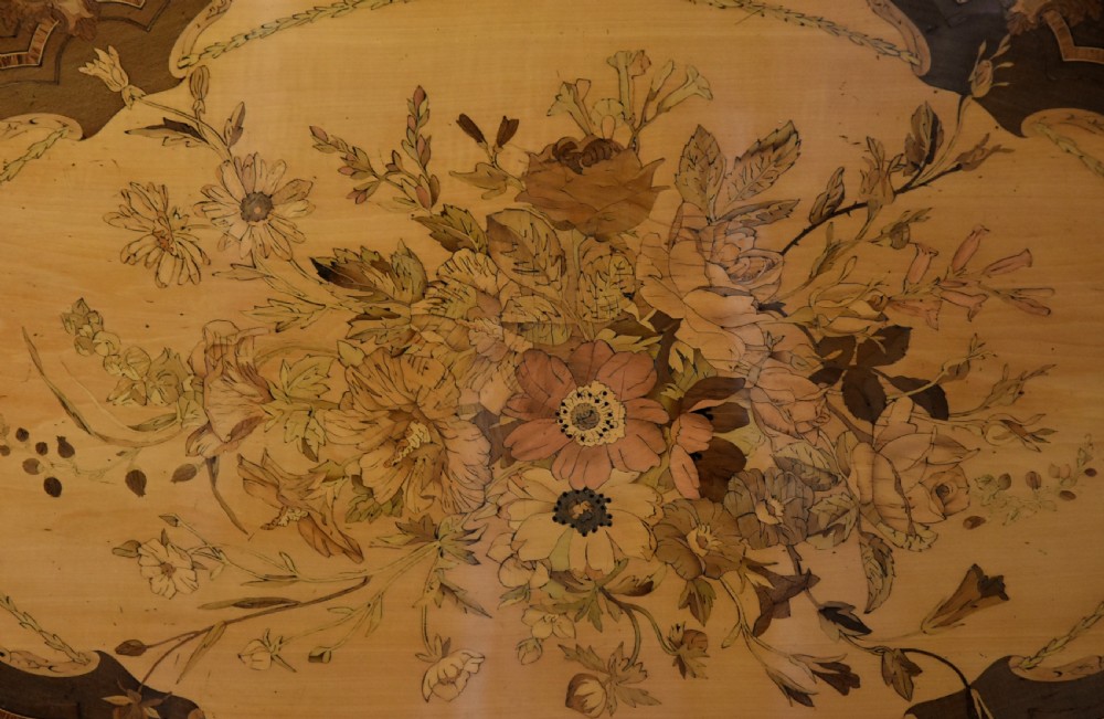 An oval mid-19th century sycamore centre table featuring intricate floral marquetry, ormolu trim, and a turned pedestal with four swept legs. View X
