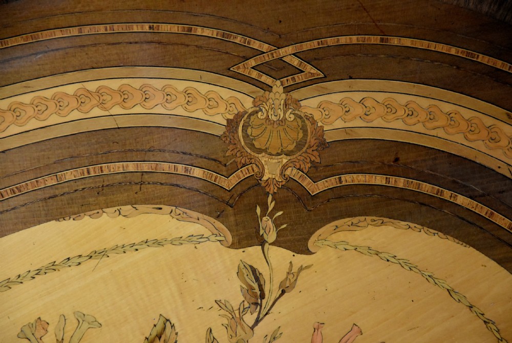 An oval mid-19th century sycamore centre table featuring intricate floral marquetry, ormolu trim, and a turned pedestal with four swept legs. View XI