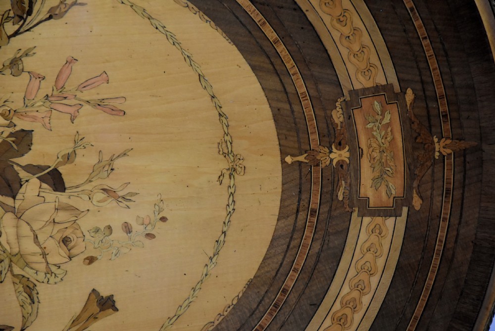 An oval mid-19th century sycamore centre table featuring intricate floral marquetry, ormolu trim, and a turned pedestal with four swept legs. View XII