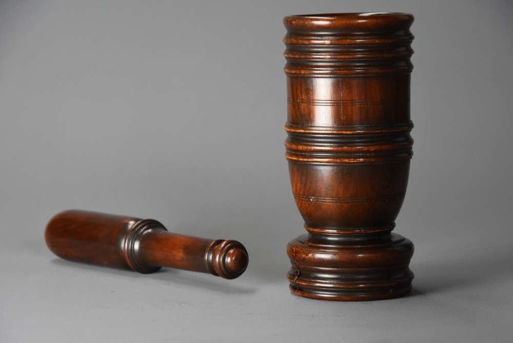 A mid-19th century turned walnut pestle and mortar with horizontal moulded bands and a polished brown finish. View VII
