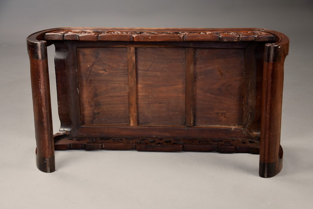 An early 20th-century rectangular Chinese low table crafted from warm brown padouk wood, featuring a carved openwork apron and rounded legs with scroll feet. View XII