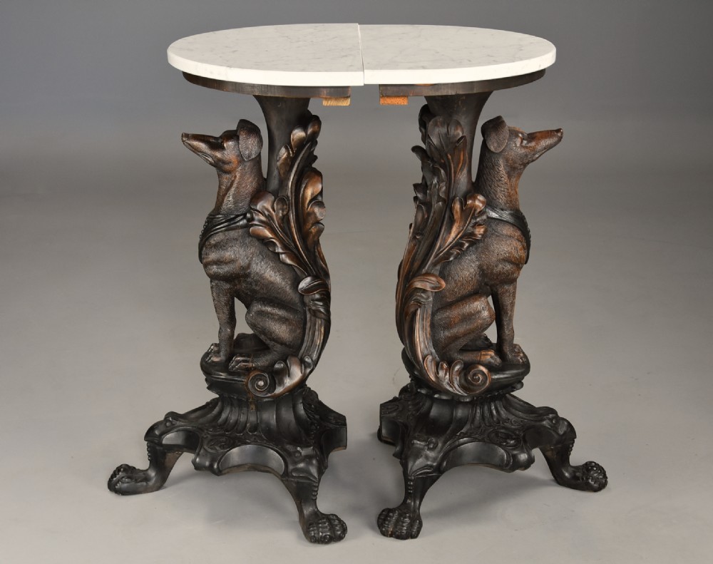 Pair of late 19th-century Black Forest demilune side tables featuring carved seated hound pedestals and white marble tops. View V