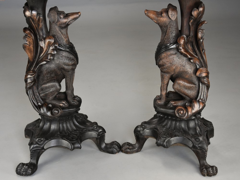 Pair of late 19th-century Black Forest demilune side tables featuring carved seated hound pedestals and white marble tops. View X