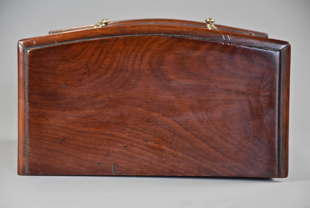 A Victorian miniature mahogany bow front chest of drawers featuring turned feet and brass knob handles. View XI