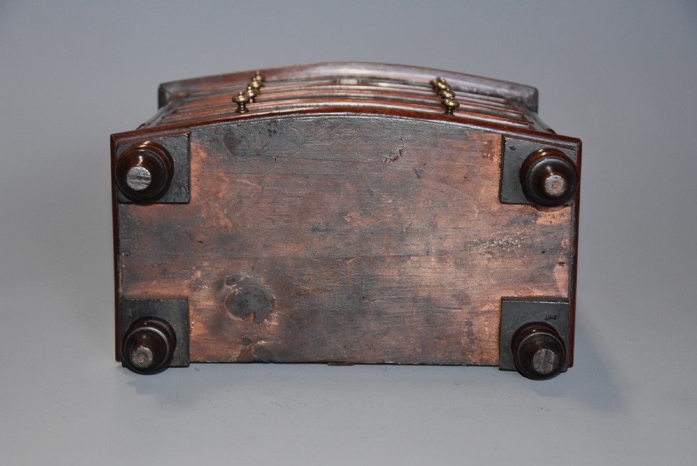 A Victorian miniature mahogany bow front chest of drawers featuring turned feet and brass knob handles. View XIII
