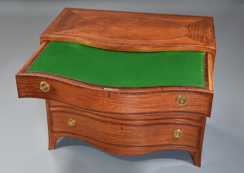 A late eighteenth-century George III serpentine-front satinwood dressing chest featuring four graduated drawers with brass rosette handles. View IX