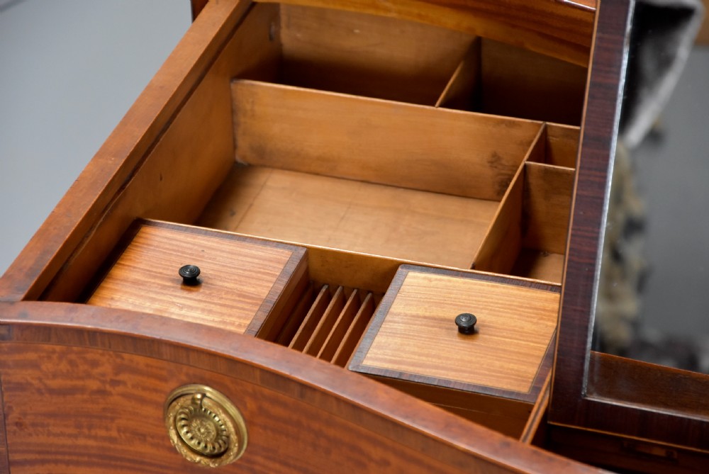 A late eighteenth-century George III serpentine-front satinwood dressing chest featuring four graduated drawers with brass rosette handles. View XII