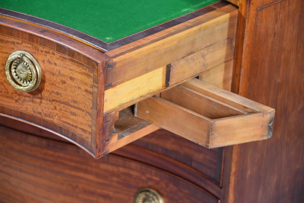 A late eighteenth-century George III serpentine-front satinwood dressing chest featuring four graduated drawers with brass rosette handles. View XIII