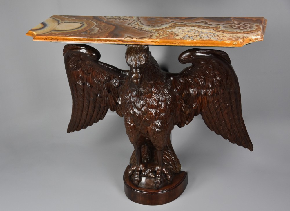 A late 18th-century Baroque carved dark walnut console table featuring a detailed eagle with outstretched wings resting on a rounded base and supporting a polished stone top. View III