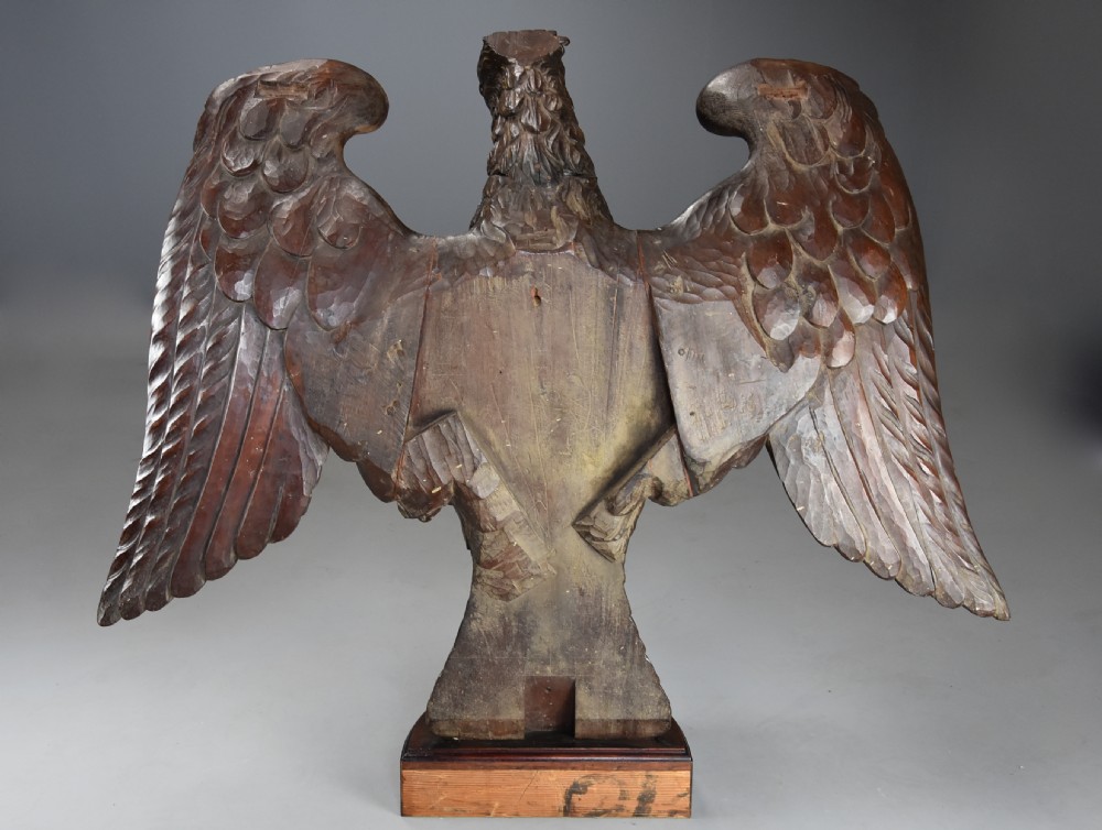 A late 18th-century Baroque carved dark walnut console table featuring a detailed eagle with outstretched wings resting on a rounded base and supporting a polished stone top. View XVII