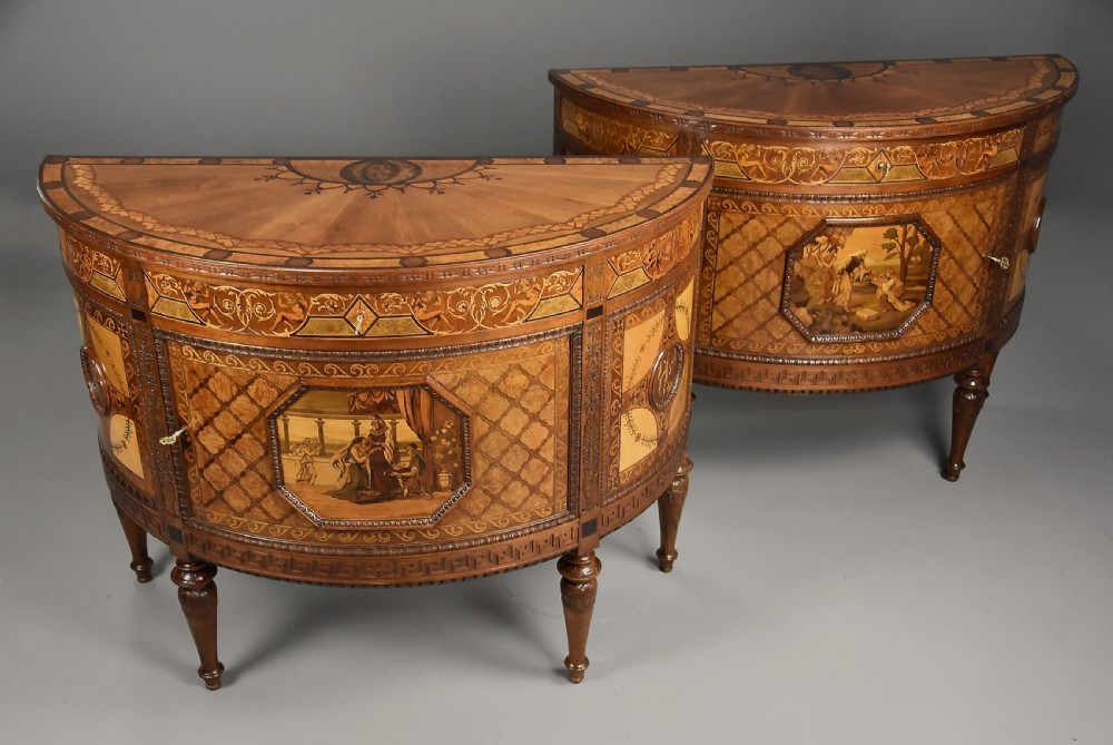 A pair of Italian Neoclassical demi-lune side cabinets featuring intricate floral and figurative marquetry inlay with tapered turned legs.