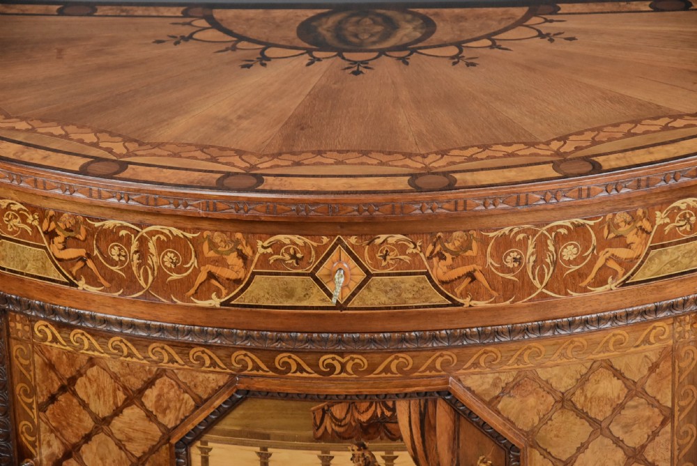 A pair of Italian Neoclassical demi-lune side cabinets featuring intricate floral and figurative marquetry inlay with tapered turned legs. View XV