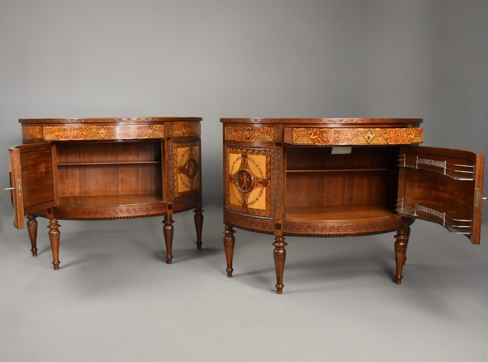 A pair of Italian Neoclassical demi-lune side cabinets featuring intricate floral and figurative marquetry inlay with tapered turned legs. View XVII