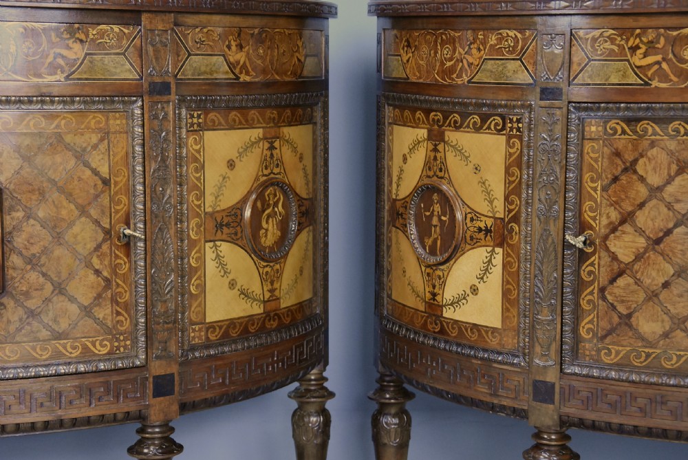 A pair of Italian Neoclassical demi-lune side cabinets featuring intricate floral and figurative marquetry inlay with tapered turned legs. View XX