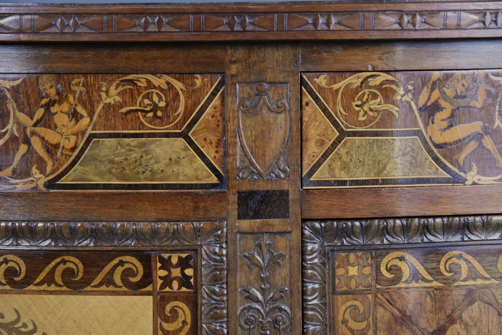 A pair of Italian Neoclassical demi-lune side cabinets featuring intricate floral and figurative marquetry inlay with tapered turned legs. View XXI