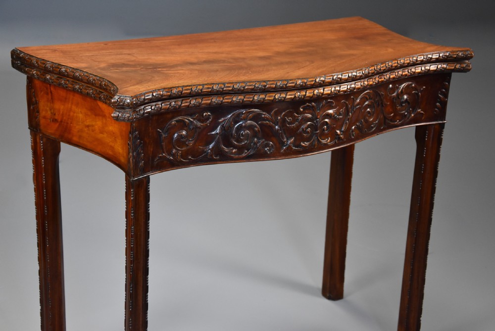 A late 19th-century Chippendale style mahogany card table featuring a serpentine front with carved foliage and square molded legs. View III