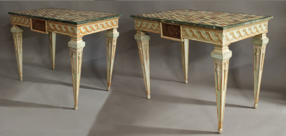 A pair of Italian hand-painted Neoclassical console tables featuring tapered fluted legs, classical relief plaques, and geometric specimen marble tops. View III