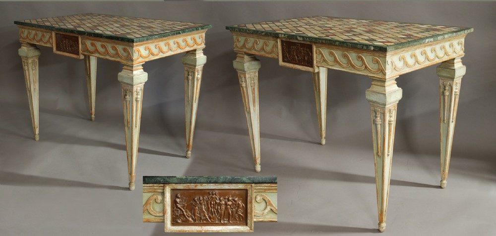 A pair of Italian hand-painted Neoclassical console tables featuring tapered fluted legs, classical relief plaques, and geometric specimen marble tops.