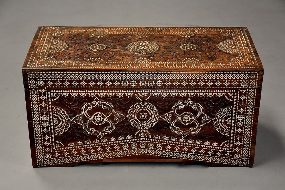 A dark hardwood coffer decorated with detailed geometric mother-of-pearl inlay and relief carvings across the lid and front. View III