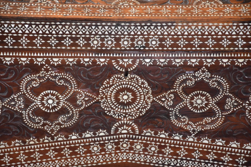 A dark hardwood coffer decorated with detailed geometric mother-of-pearl inlay and relief carvings across the lid and front. View IV