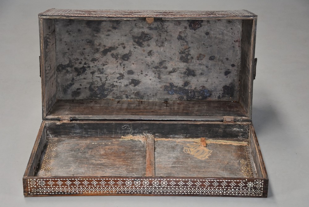 A dark hardwood coffer decorated with detailed geometric mother-of-pearl inlay and relief carvings across the lid and front. View XI