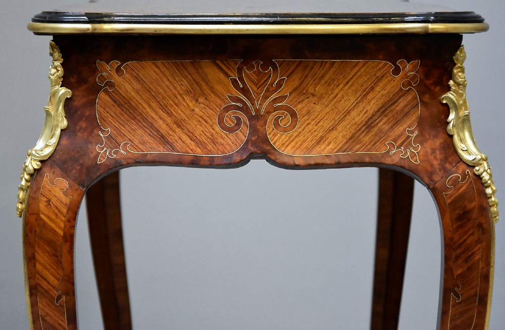 A 19th-century French kingwood occasional table featuring serpentine sides, parquetry veneer top, floral inlay, ormolu mounts, frieze drawer, and cabriole legs. View IX