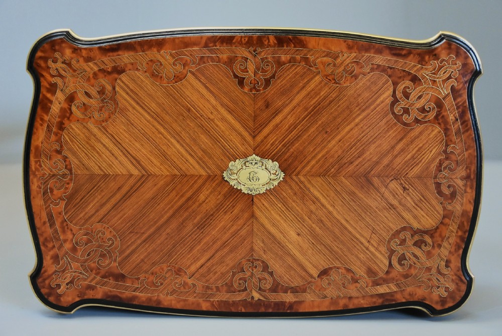 A 19th-century French kingwood occasional table featuring serpentine sides, parquetry veneer top, floral inlay, ormolu mounts, frieze drawer, and cabriole legs. View X