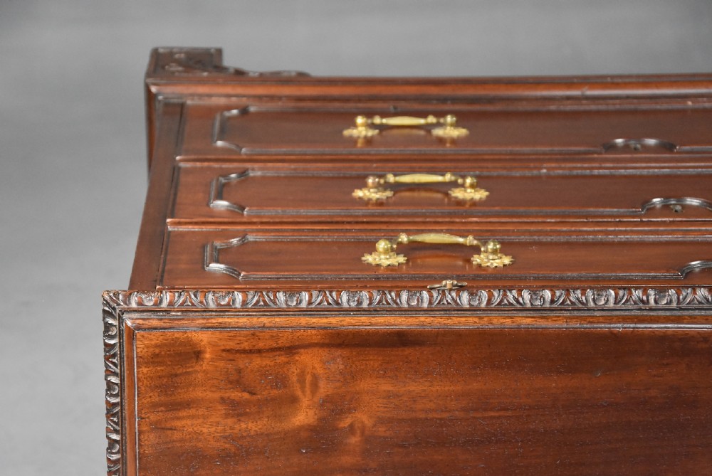 A late 19th-century dark mahogany chest of drawers featuring three graduated drawers, ornate brass swan-neck handles, a pull-out brushing slide, and carved bracket feet. View XIII