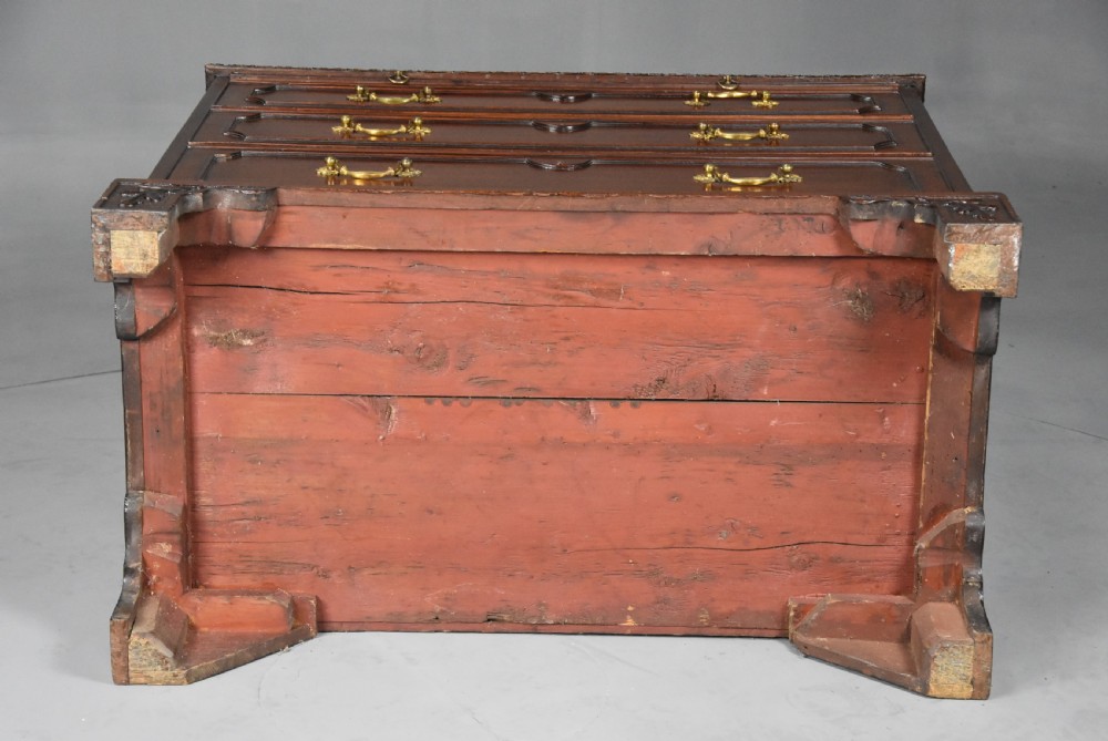 A late 19th-century dark mahogany chest of drawers featuring three graduated drawers, ornate brass swan-neck handles, a pull-out brushing slide, and carved bracket feet. View XV