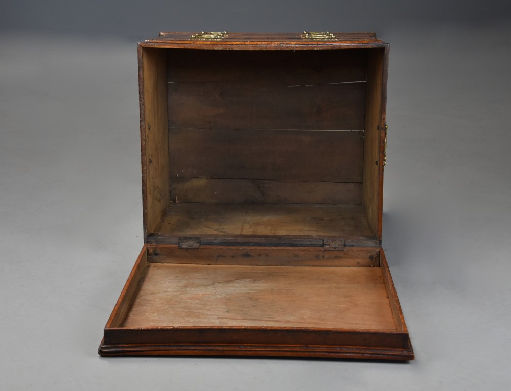 A late eighteenth-century warm brown elm wooden box designed in the form of a miniature chest of drawers with brass handles and bracket feet. View XIII