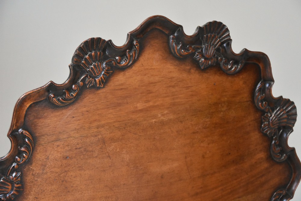 A late 19th-century mahogany tilt-top table featuring a carved piecrust border with shell detailing on a tripod base. View VI