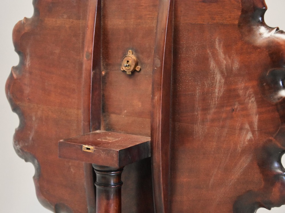 A late 19th-century mahogany tilt-top table featuring a carved piecrust border with shell detailing on a tripod base. View XII