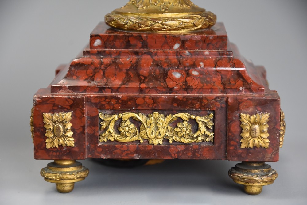 A pair of late 19th-century French table lamps styled as patinated bronze classical urns with gilt bronze handles and mounts, set upon square red marble bases. View XI