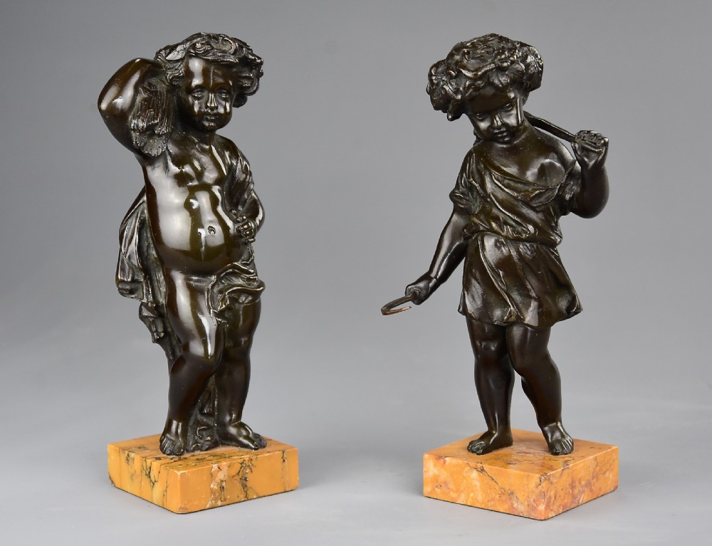 A pair of late 19th-century dark bronze figures depicting harvest putti mounted on rectangular yellow marble bases. View III