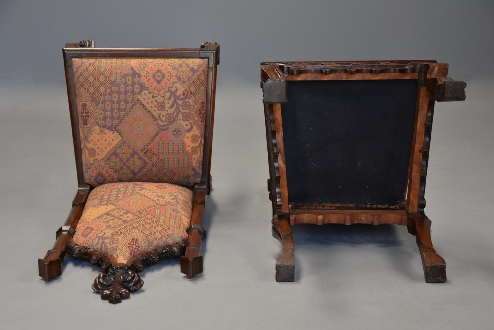 A pair of mid-19th century carved rosewood Gothic Revival hall chairs featuring pointed arch backs, decorative finials, patterned fabric upholstery, and cabriole legs. View XII