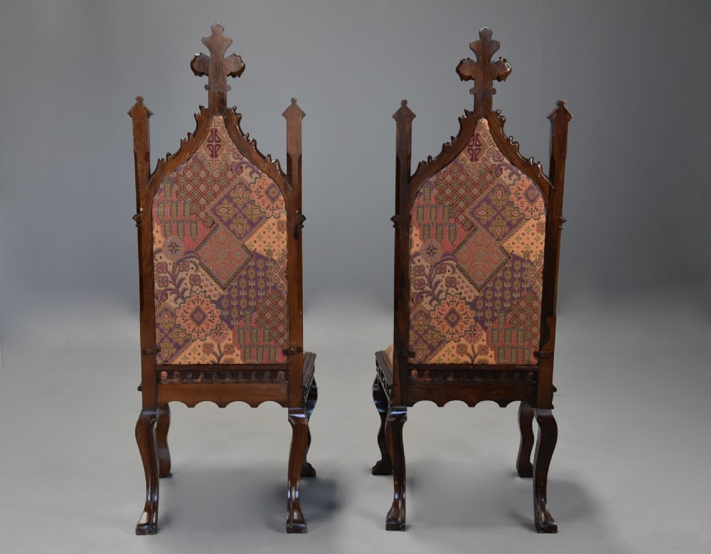 A pair of mid-19th century carved rosewood Gothic Revival hall chairs featuring pointed arch backs, decorative finials, patterned fabric upholstery, and cabriole legs. View XIII