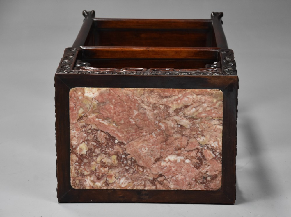 A late 19th-century rectangular Chinese dark hardwood pot stand featuring a pink marble insert top, pierced openwork aprons, and two lower tiers. View VIII