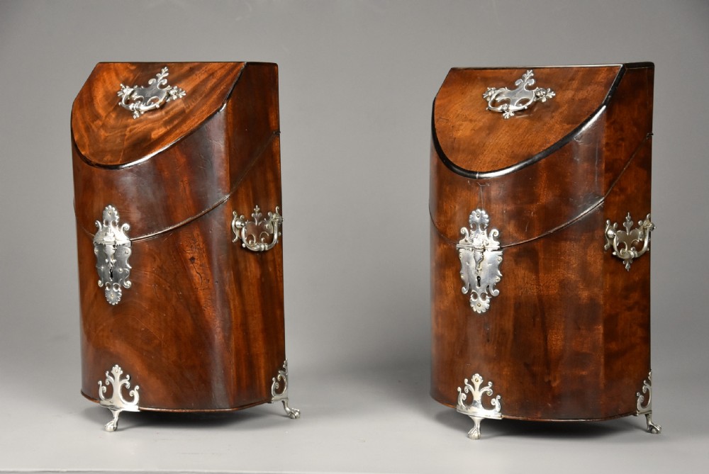 A pair of late eighteenth-century bow-front mahogany cutlery boxes with silver mounts and claw feet. View II