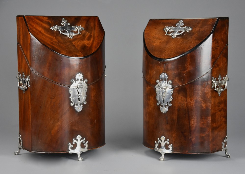 A pair of late eighteenth-century bow-front mahogany cutlery boxes with silver mounts and claw feet. View V