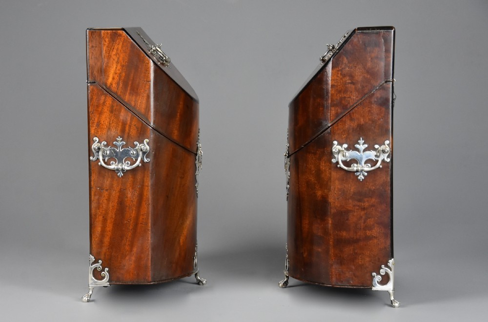 A pair of late eighteenth-century bow-front mahogany cutlery boxes with silver mounts and claw feet. View X