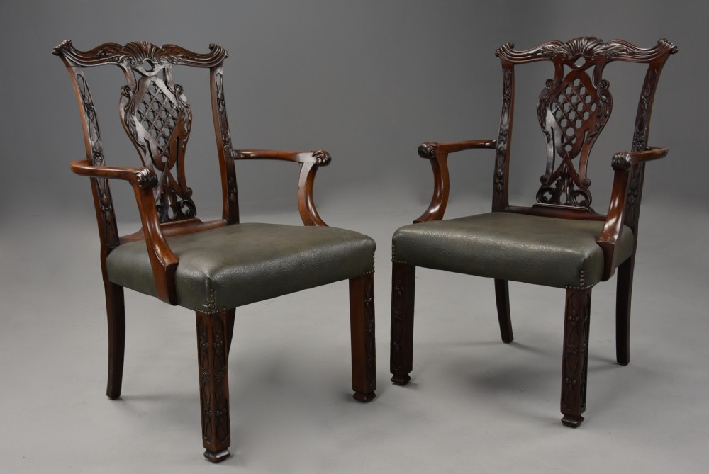 A pair of late nineteenth century mahogany open armchairs featuring carved pierced splat backs and dark green leather upholstered seats. View II