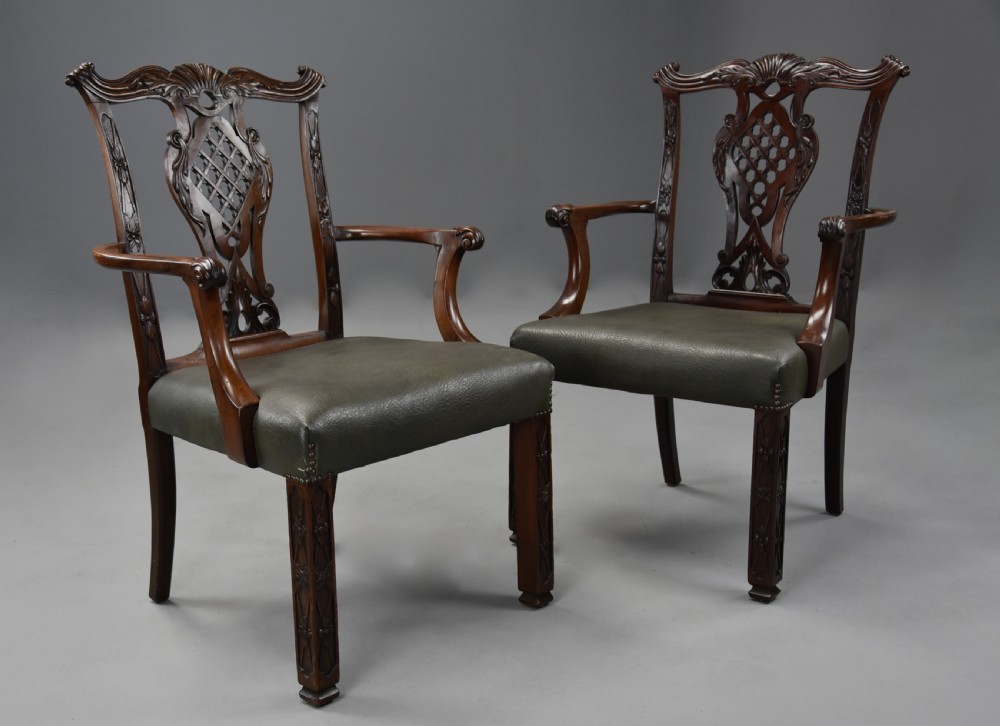A pair of late nineteenth century mahogany open armchairs featuring carved pierced splat backs and dark green leather upholstered seats. View III