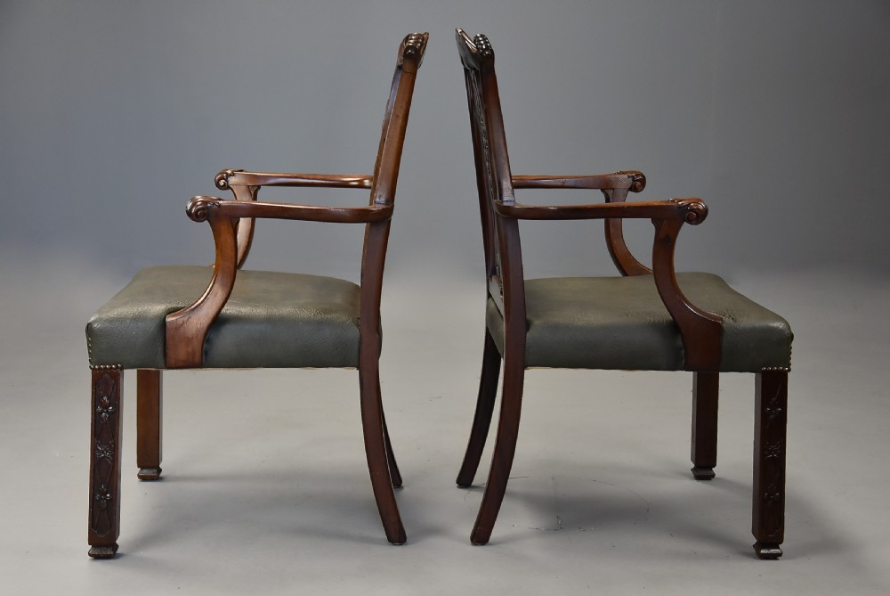 A pair of late nineteenth century mahogany open armchairs featuring carved pierced splat backs and dark green leather upholstered seats. View XI