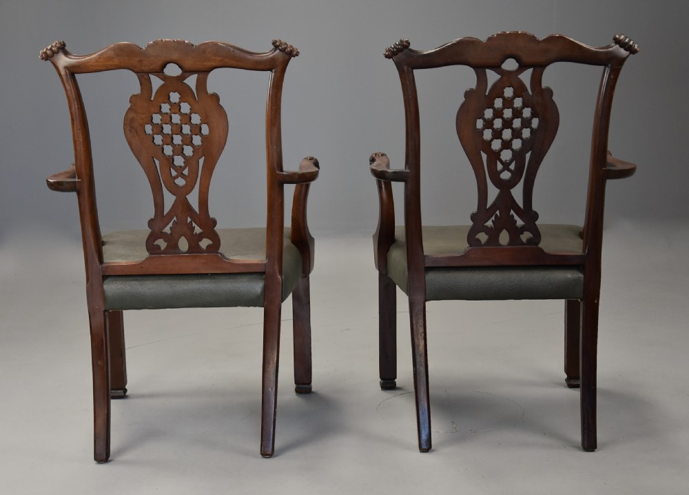 A pair of late nineteenth century mahogany open armchairs featuring carved pierced splat backs and dark green leather upholstered seats. View XIII